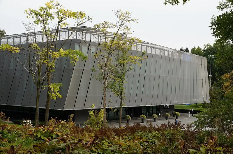 Gedung Home of FIFA di Zurich berfasad logam dikelilingi pepohonan