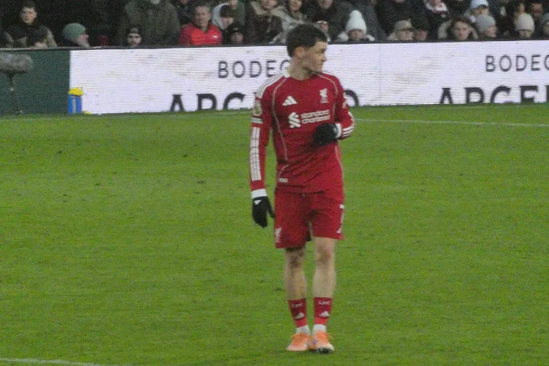 Florian Wirtz berseragam merah Liverpool berdiri di lapangan Craven Cottage